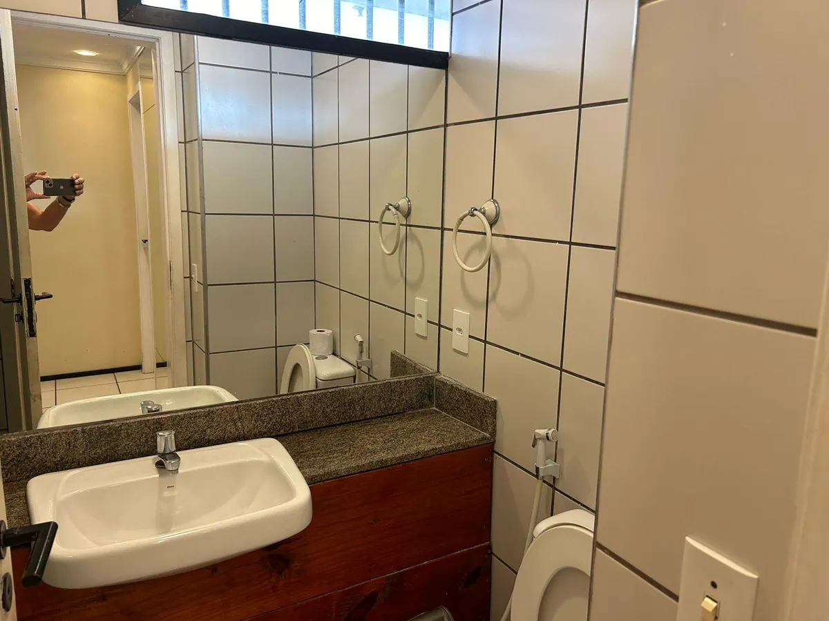 Segundo baño del apartamento, con encimera de granito y espejo